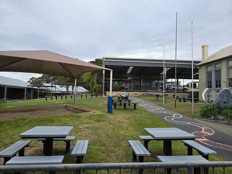 Photo of top playground, showing student seating, sandpit and COLA area.